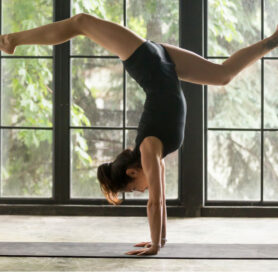 woman doing yoga and balancing weight on wrist