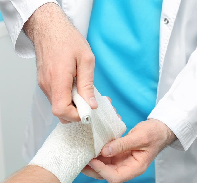 A doctor putting bandage to a patien's hand