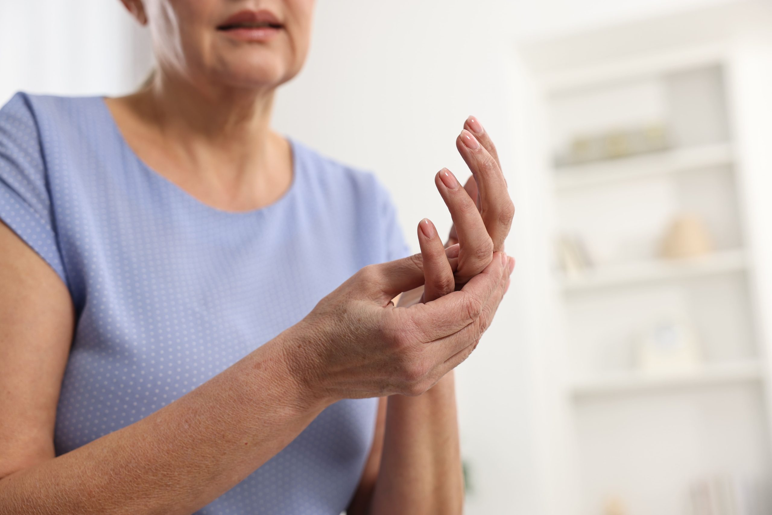 Image mature woman rubbing her sore hand indoors 2026 04 09 04 33 59 utc (1)